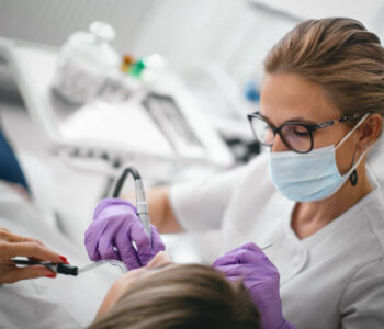 Dentist repairing the patient's teeth in the dental office.